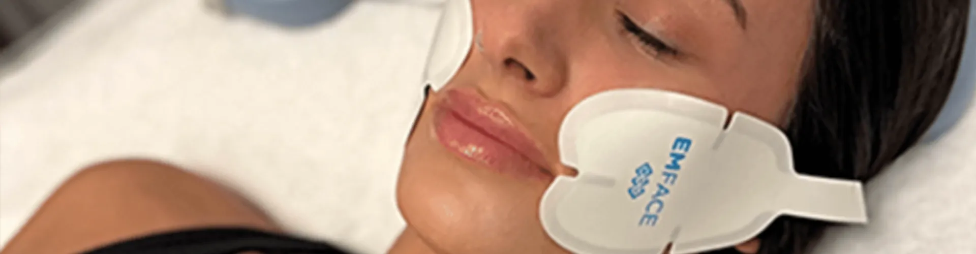 Woman receiving EMFACE treatment.
