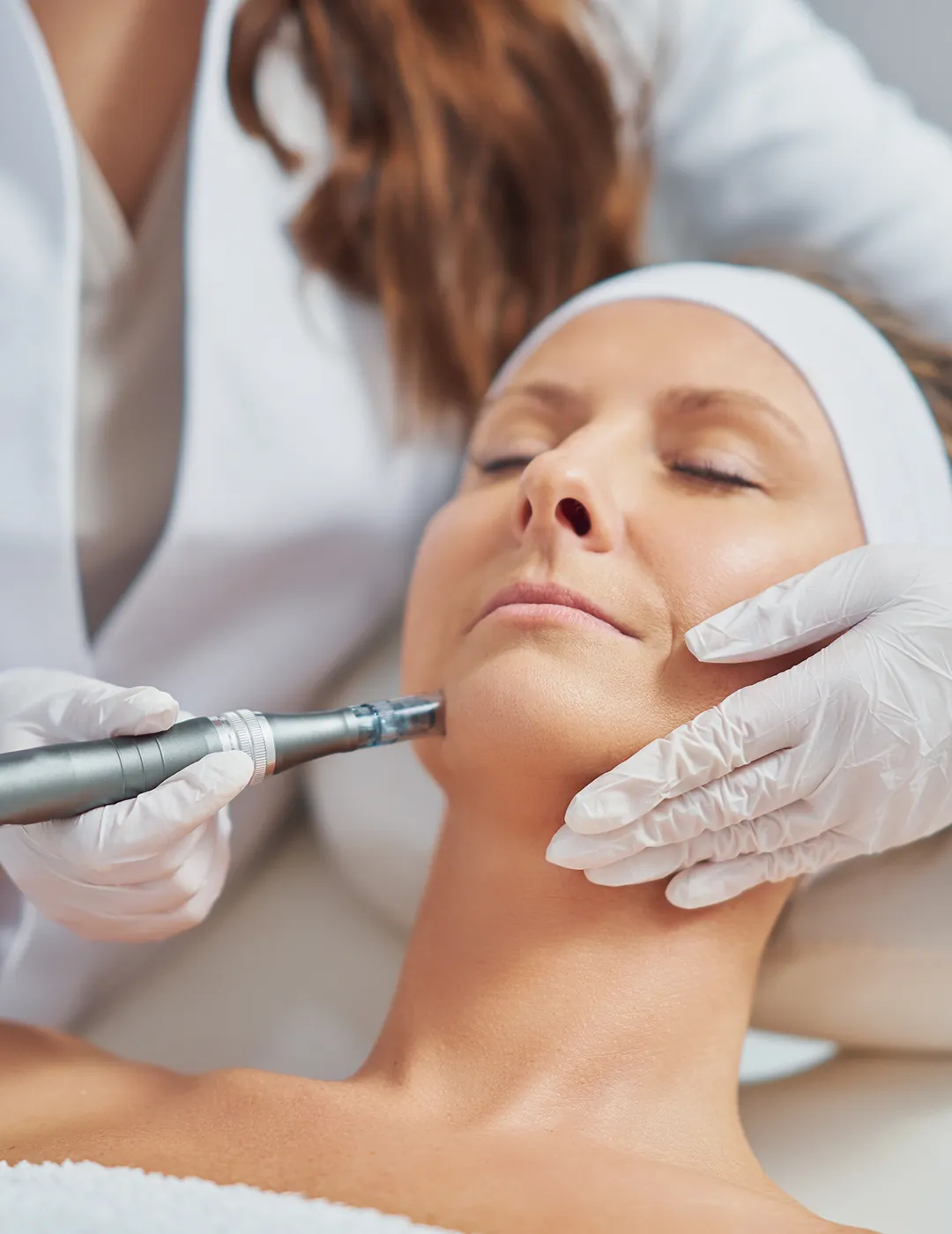 A woman receiving microneedling treatment.
