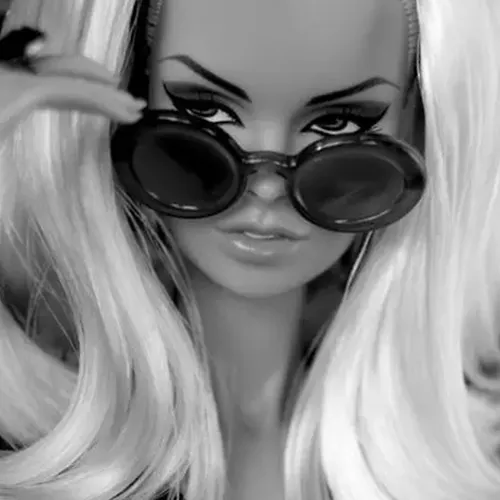 A portrait of a barbie face with sunglasses.