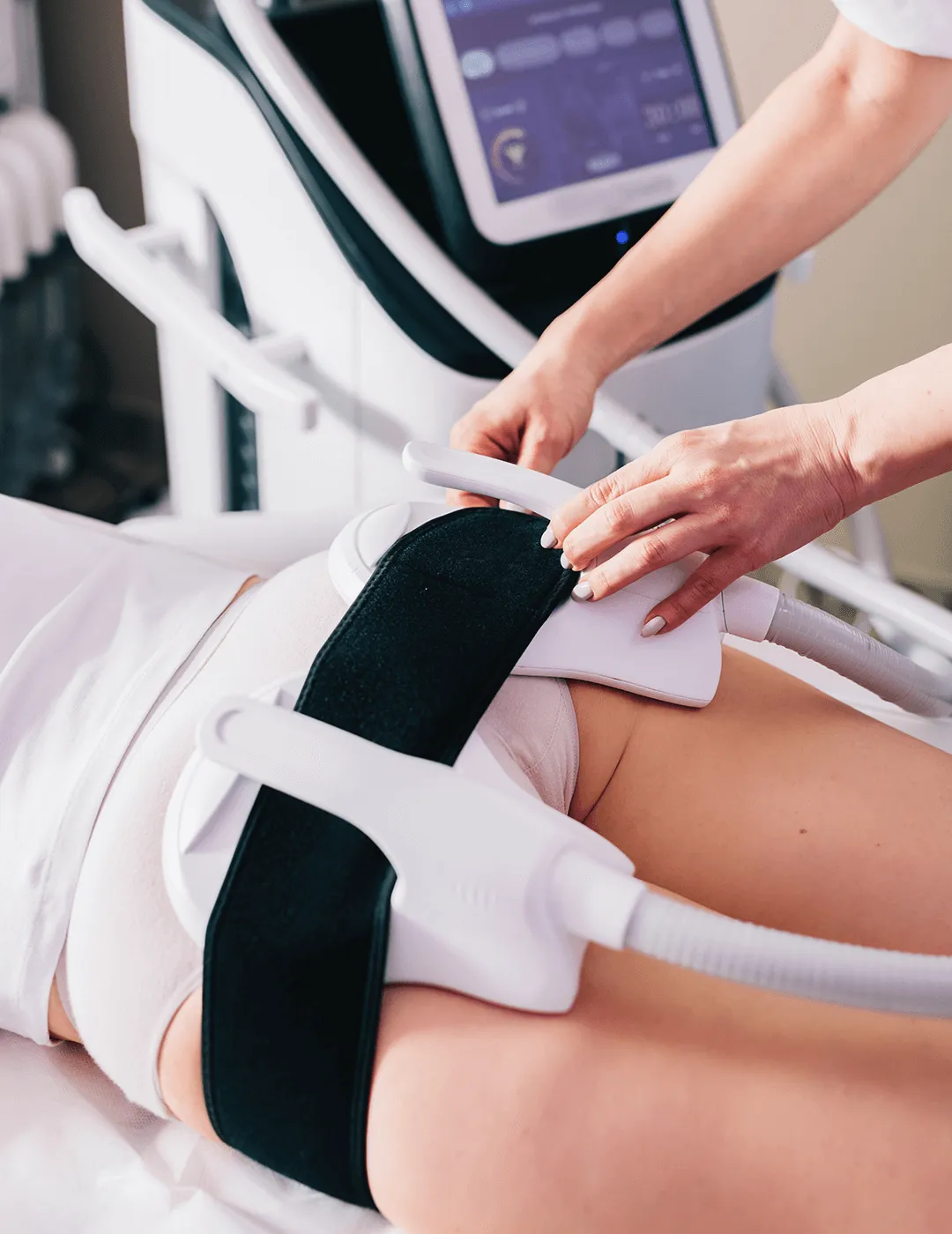 A woman receiving an EMSCULPT NEO treatment.