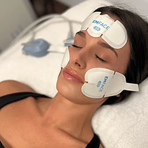 Woman receiving EMFACE treatment.