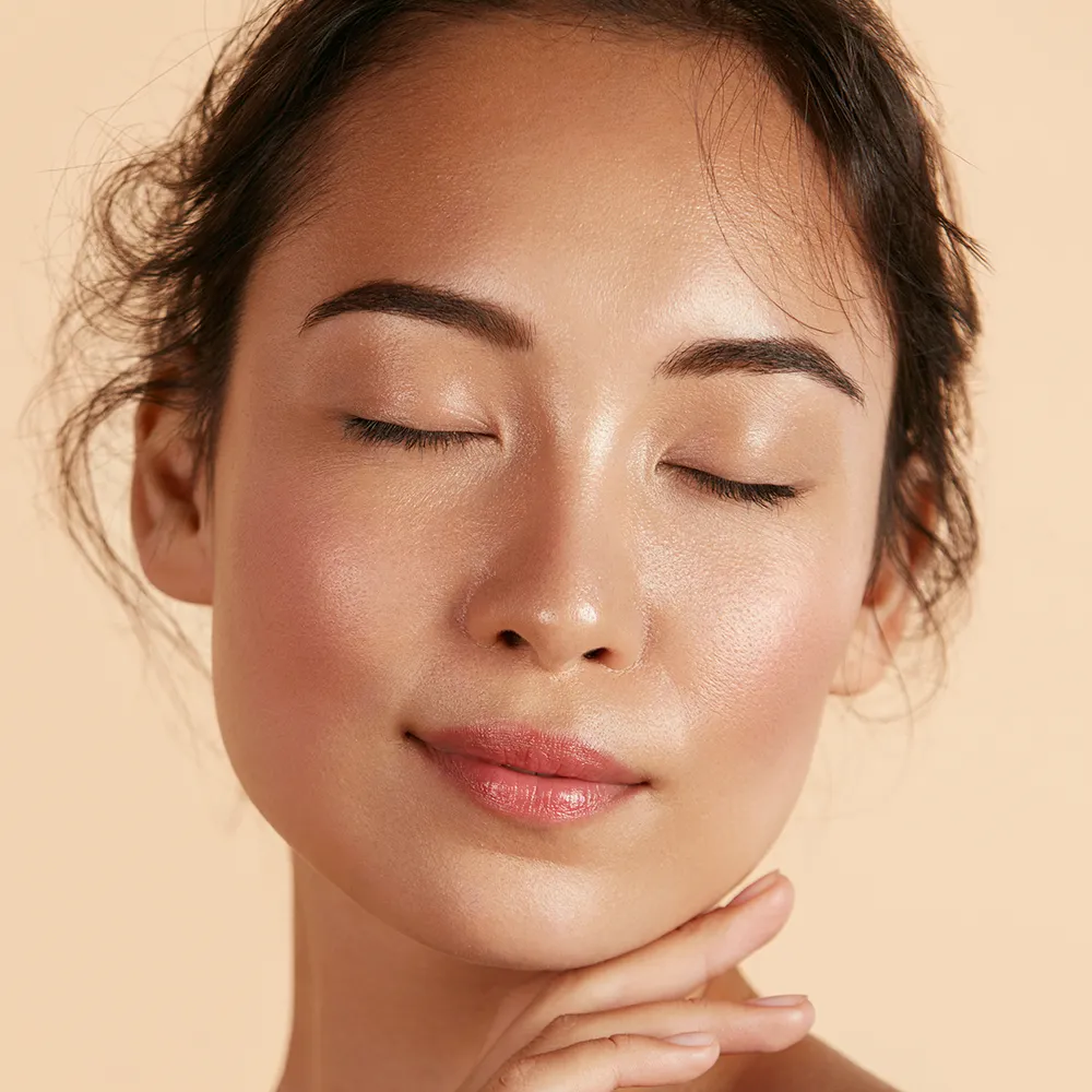 A close-up of a woman with closed eyes.