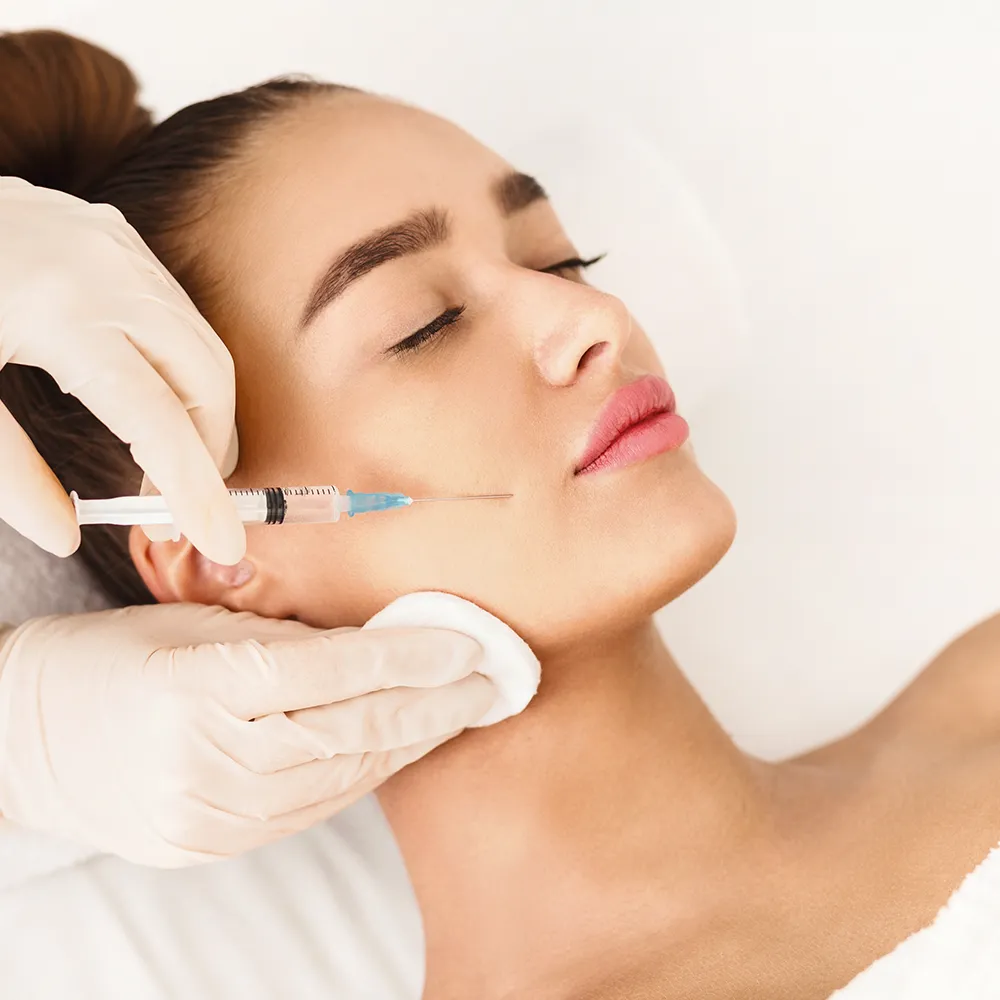 A woman receiving Botox injections in her face.