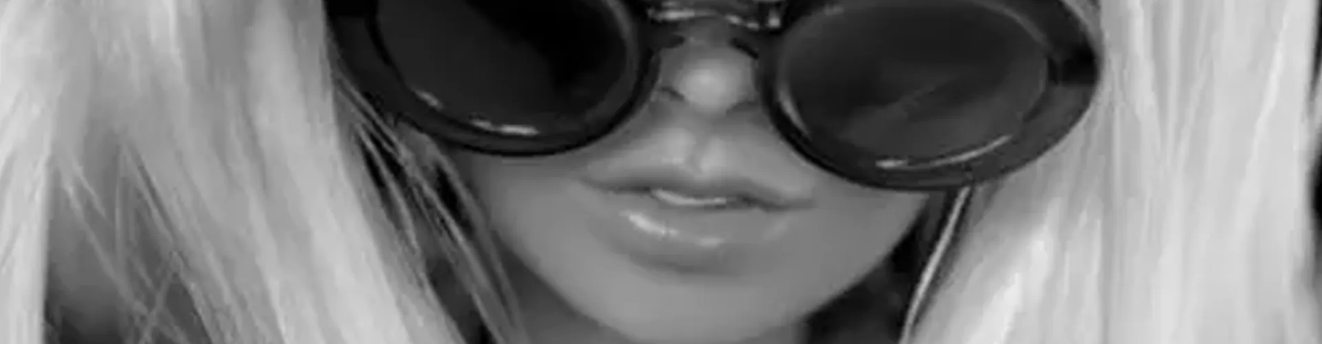 A portrait of a barbie face with sunglasses.