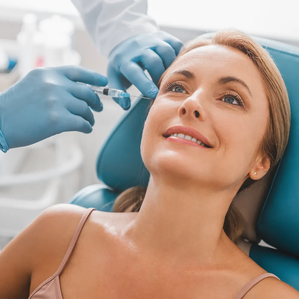 A woman receiving Botox injections in her face.